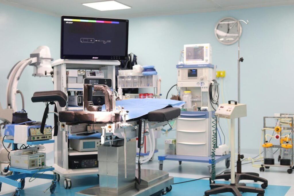 A medical room with a large screen and medical equipment