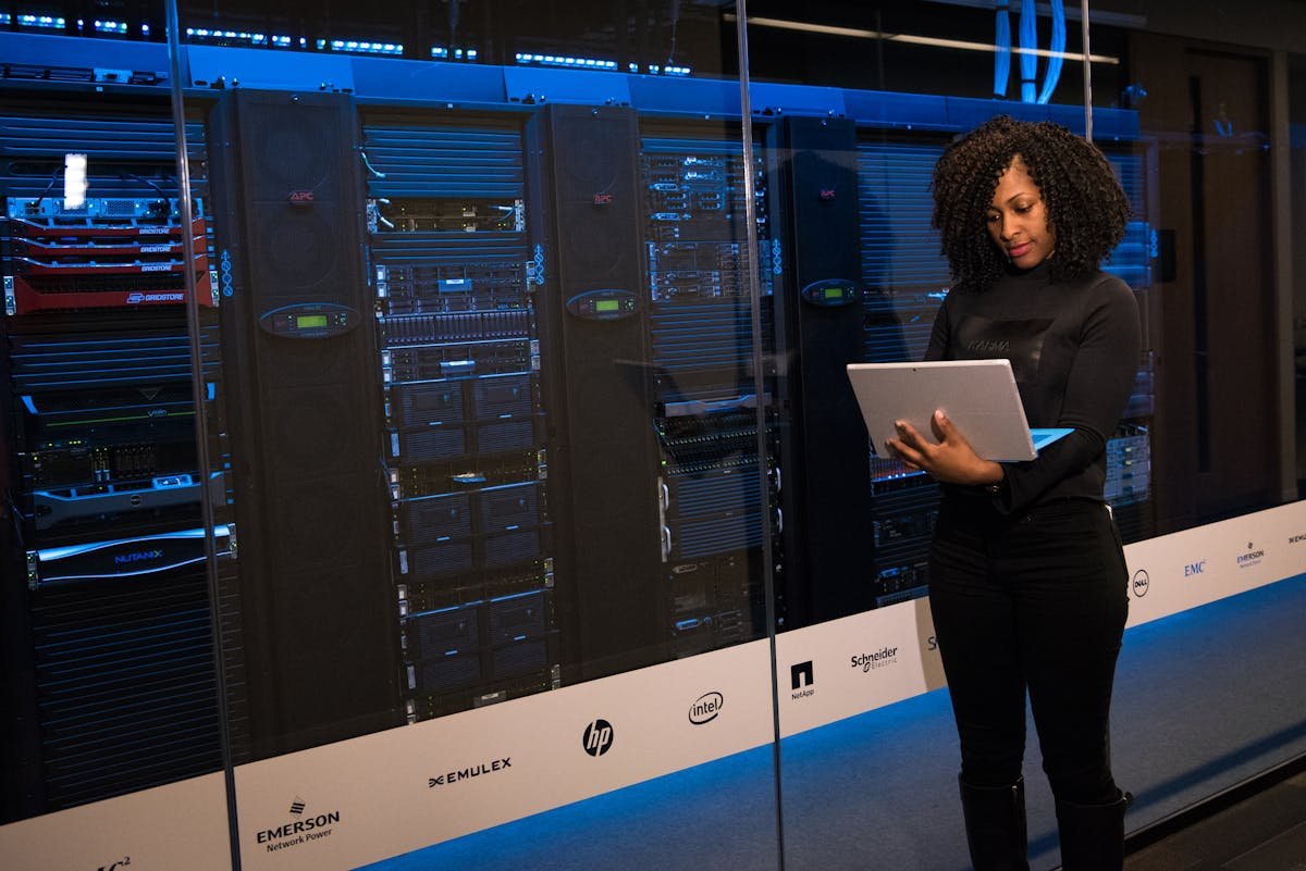Engineer monitoring server racks in data center